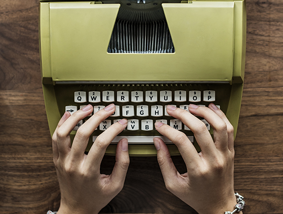 Aerial view of a man typing on a retro typewriter